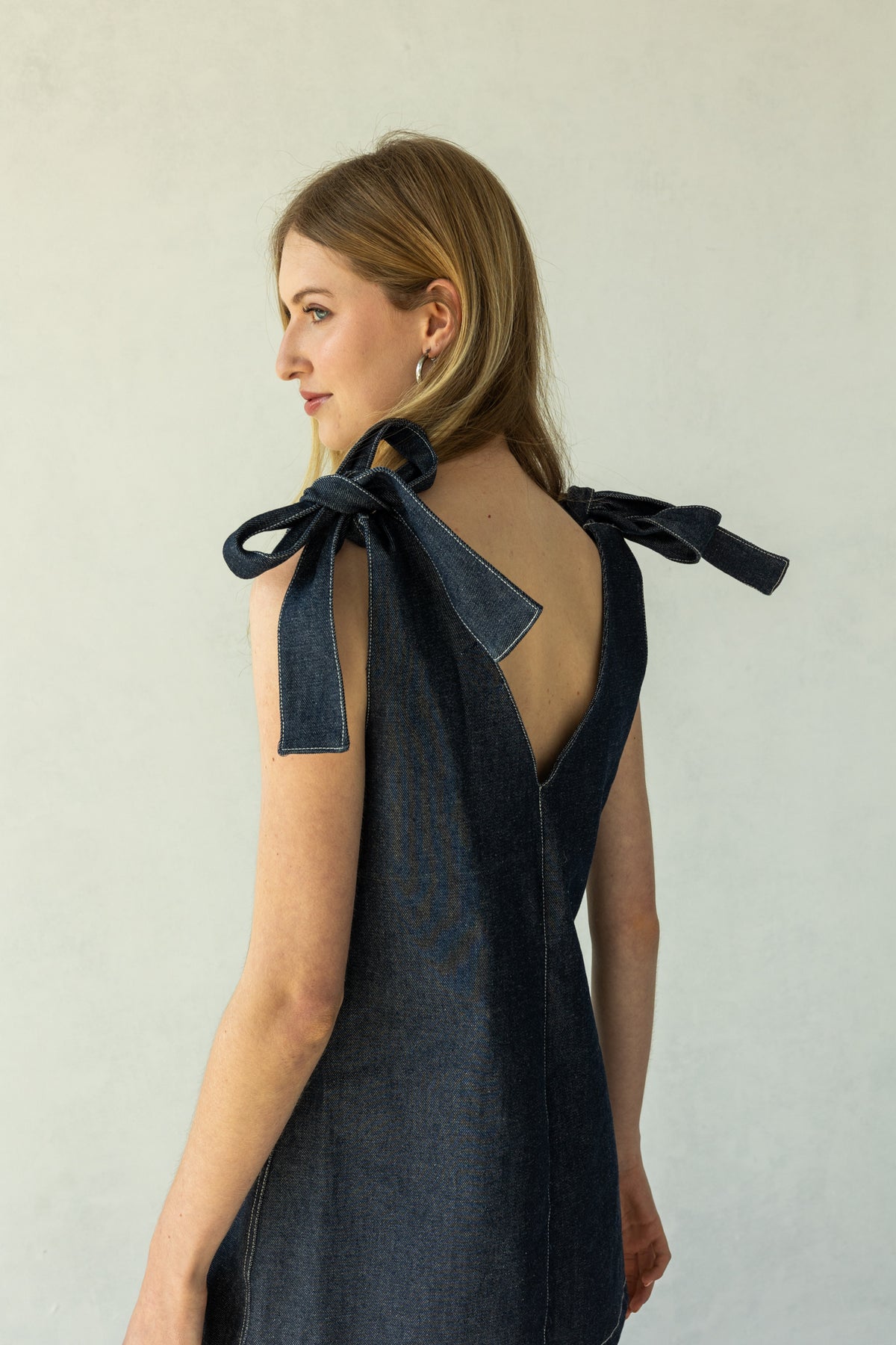 Rokkie Denim 09 / 05 Dress — deep V-neck mini dress, tied straps at the open back