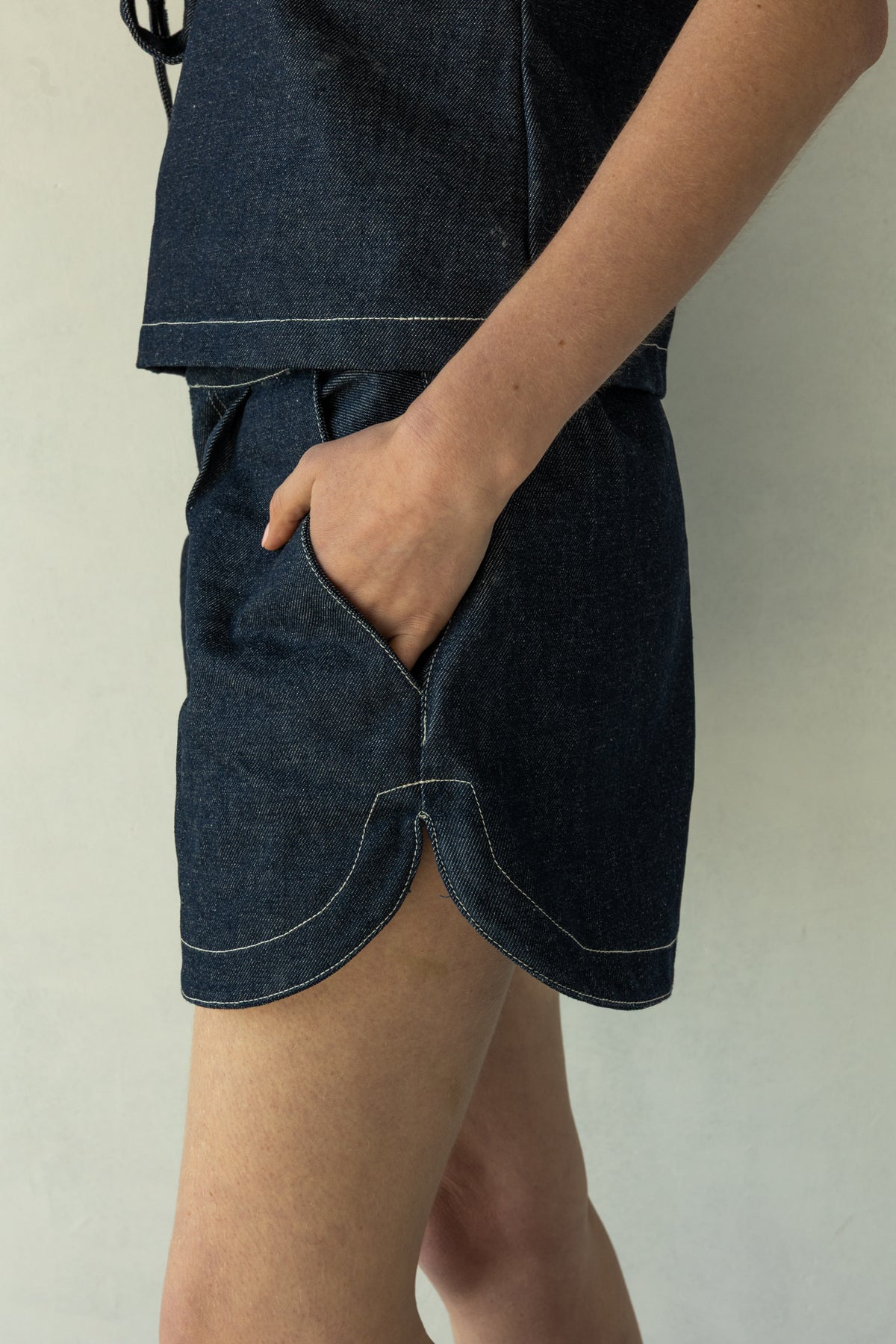 Rokkie Denim 09 / 04 Short — high-waisted short, curved hem at the side seam