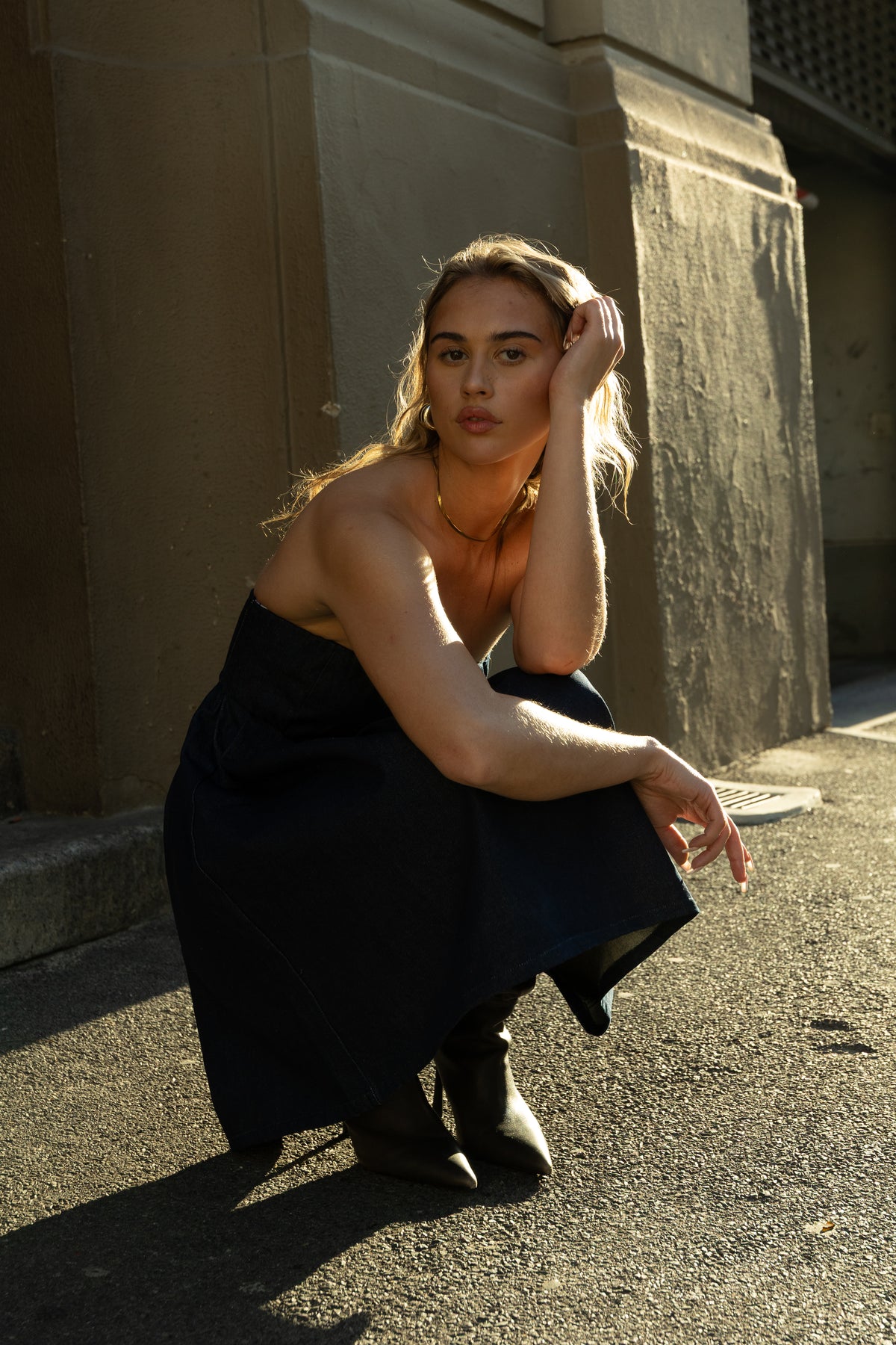 Rokkie Denim No. 05 Dress — seated, detail of pleated skirt