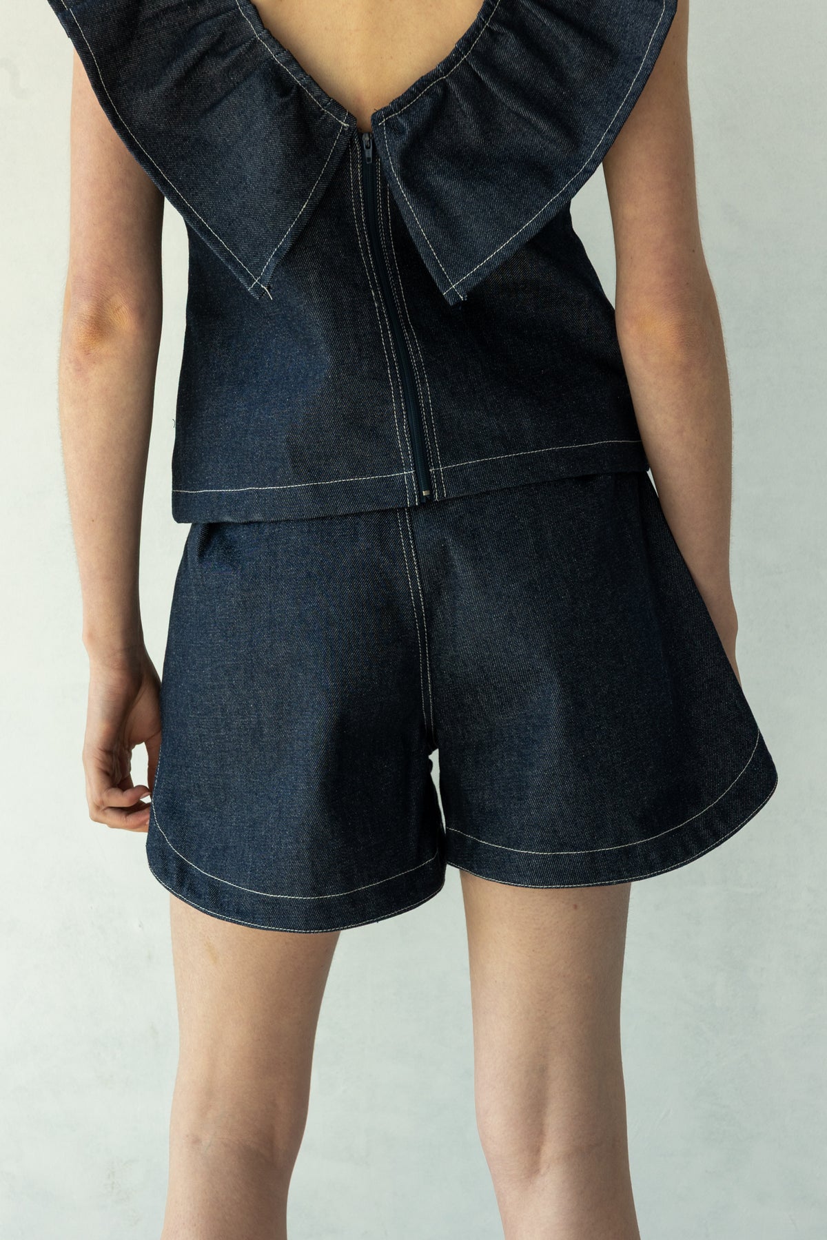 Rokkie Denim 09 / 04 Short — high-waisted short, curved hem at the side seam